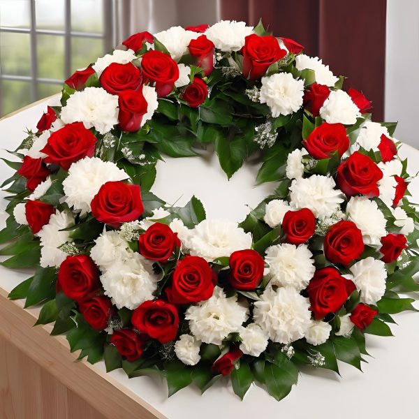 Corona funeraria de claveles rojos y blancos